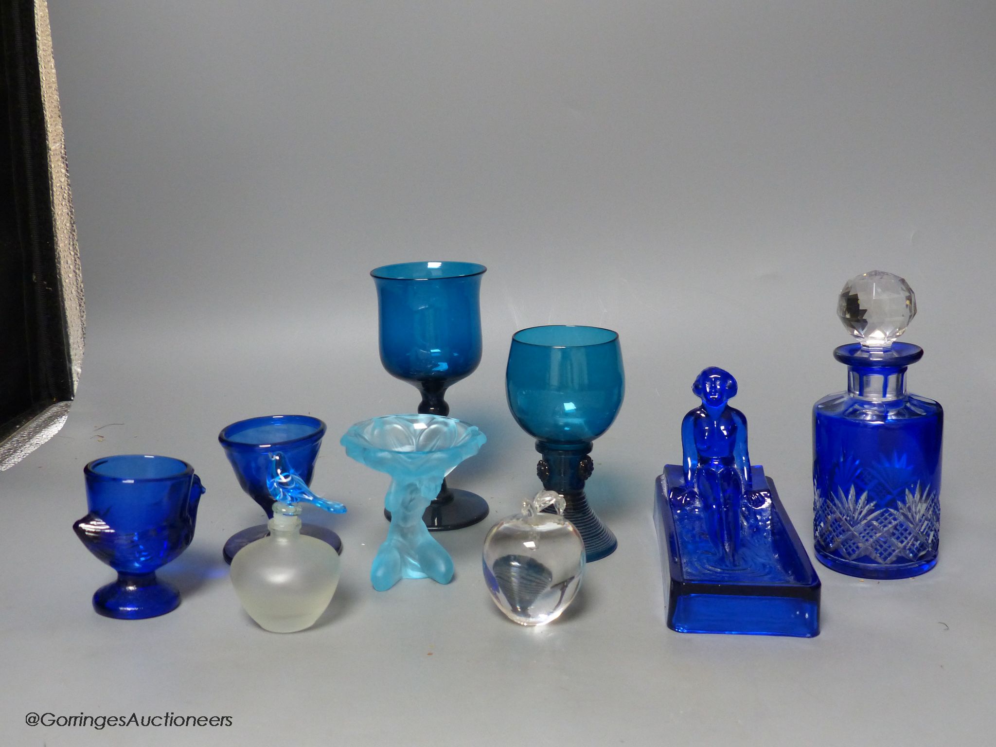 Nine pieces of coloured glassware, including a roemer, a wine glass and a cut glass scent bottle